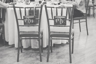 Empty chairs and tables at sidewalk cafe