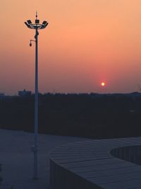 Street light against sky at sunset