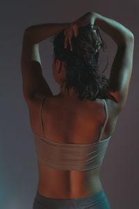 Rear view of woman standing against white background