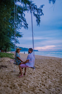 People on beach against sky