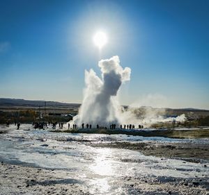 Scenic view of smoke emitting from geyser against clear sky