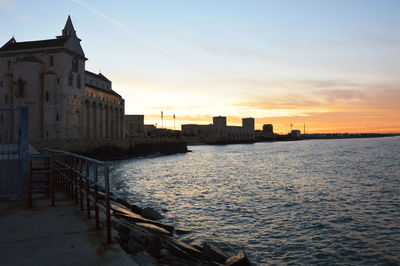 View of buildings in city at sunset