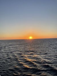 Scenic view of sea against clear sky during sunset