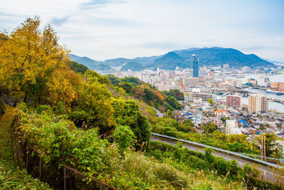 Scenic view of trees and buildings against sky