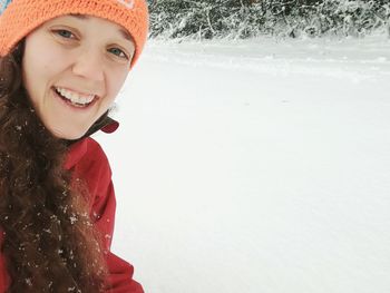 Portrait of smiling young woman in snow