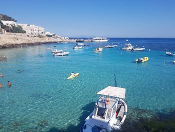 High angle view of sailboats moored on sea against clear sky