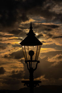 Low angle view of silhouette street light against sky during sunset