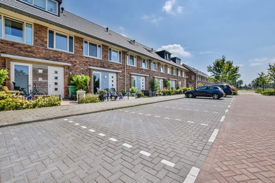 Cars on street against sky