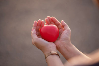 Close-up of woman holding red hand