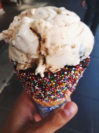 Cropped hand holding ice cream cone