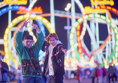 Portrait of smiling young people at amusement park