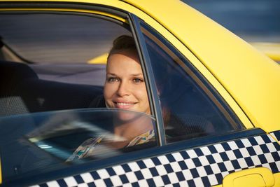 Portrait of a smiling woman in car