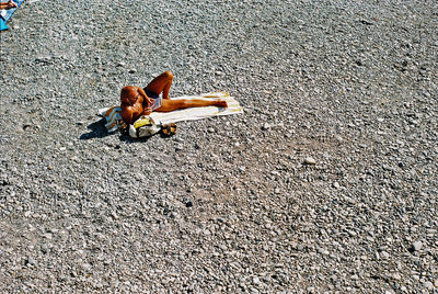 High angle view of man sitting on road