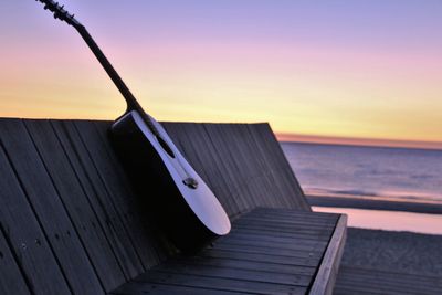 Pier over sea against sky during sunset