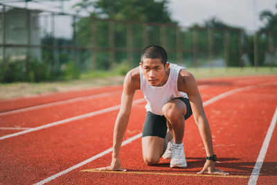 Young woman exercising on field