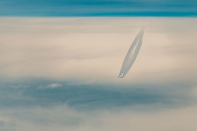 Low angle view of airplane flying against sky