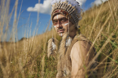 A man in traditional native american clothing in the steppe
