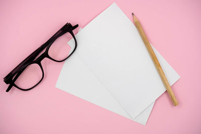 High angle view of eyeglasses on paper