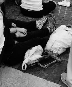 Low section of people sitting on tiled floor