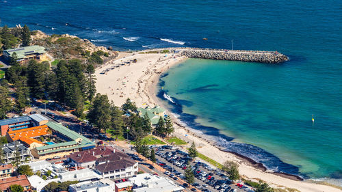 High angle view of sea and buildings in city