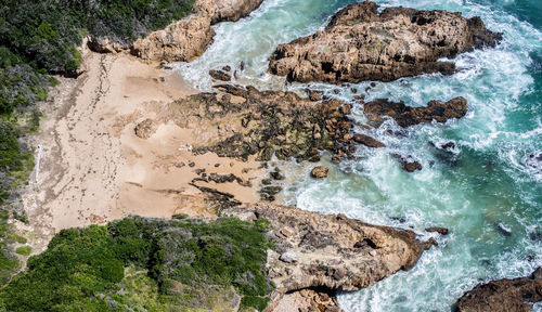 High angle view of rocks in sea