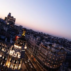 High angle view of buildings in city at sunset