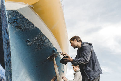 Men painting boat