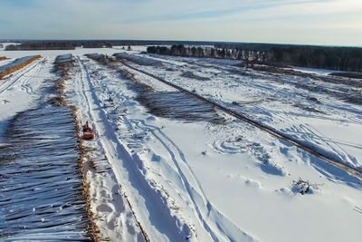 Snow covered field against sky