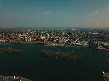 High angle view of river by buildings against sky