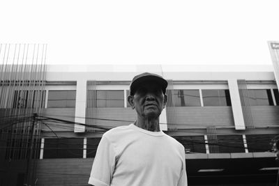 Low angle view of man standing against building