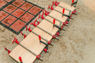 Joiner's clamps on length of bar. wooden board. top view