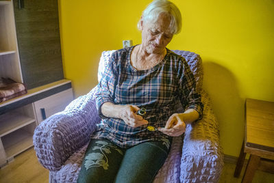 Young woman sitting on sofa at home