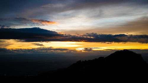 Scenic view of silhouette mountains against sky during sunset