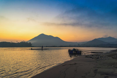 Scenic view of beach against sky during sunset