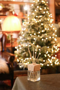 Close-up of sticks in glass bottle on table