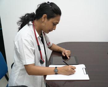 Woman using mobile phone on table