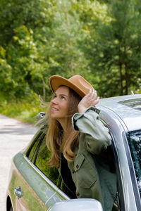 Side view of young woman using mobile phone