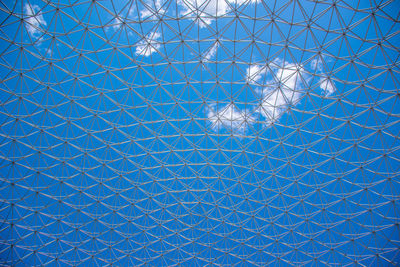Full frame shot of illuminated glass ceiling against blue sky