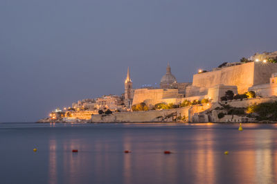 Our lady of mount carmel basilica against clear sky by sea at dusk