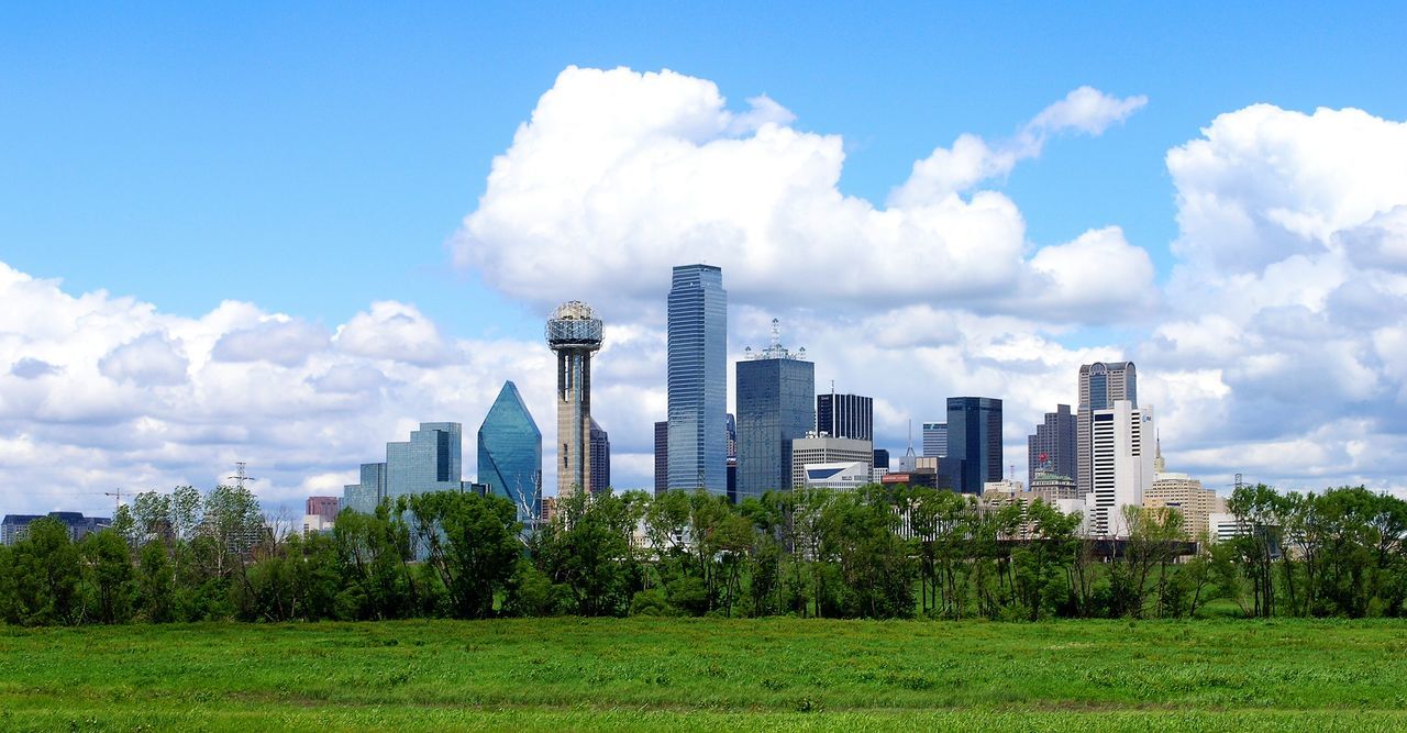 architecture, building exterior, built structure, sky, grass, skyscraper, modern, city, tree, cloud - sky, tall - high, tower, cloud, growth, green color, office building, field, cloudy, day, travel destinations