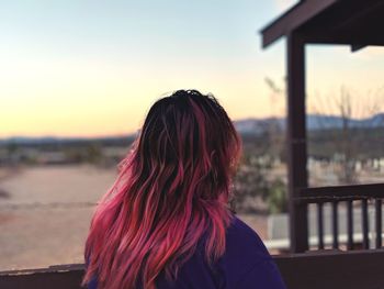 Rear view of woman looking at sunset