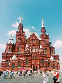 People at state historical museum against sky