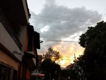 Low angle view of silhouette buildings against sky