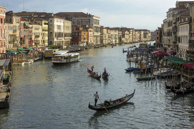 Boats in canal along city