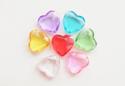 High angle view of multi colored heart shape over white background