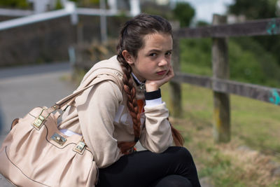 Portrait of girl sitting outdoors