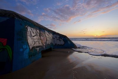 Scenic view of sea against sky during sunset. graffiti. atlantic sea. france. domsday.