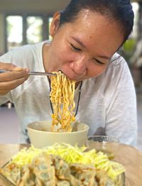 Midsection of woman eating food