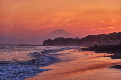 Scenic view of beach against sky during sunset