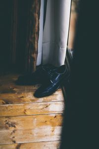 Low section of shoes hanging on wooden floor